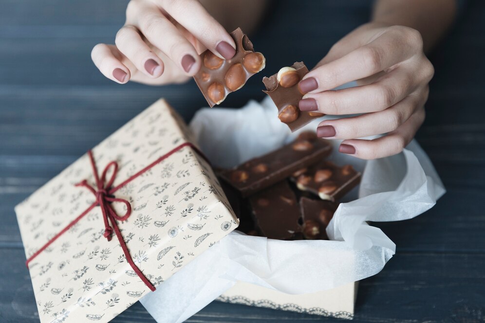 hands breaking chocolate 23 2148019523